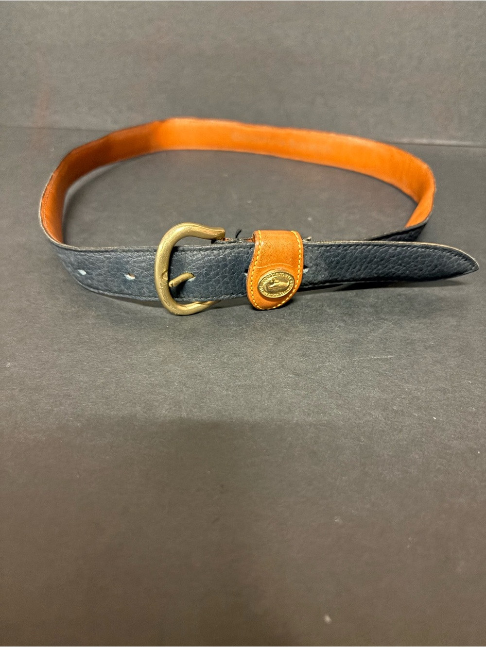 Women’s Dooney & Bourke Black and Tan Leather Belt with Brass Buckle.